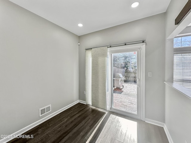 doorway to outside with wood-type flooring