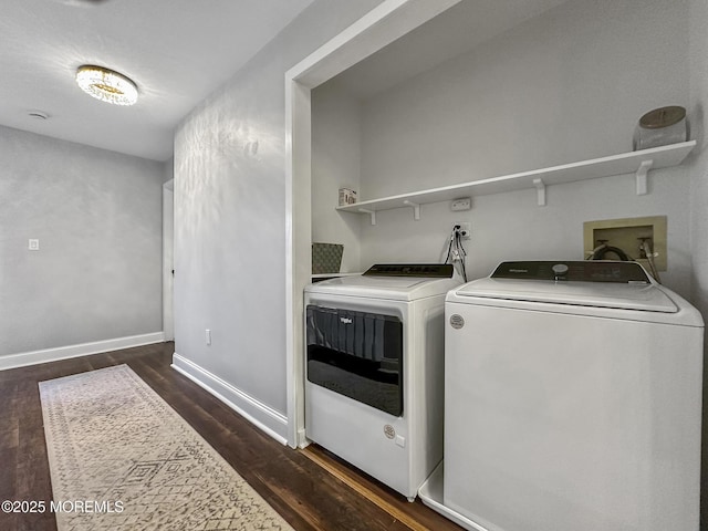 clothes washing area featuring washer and dryer and dark wood-type flooring