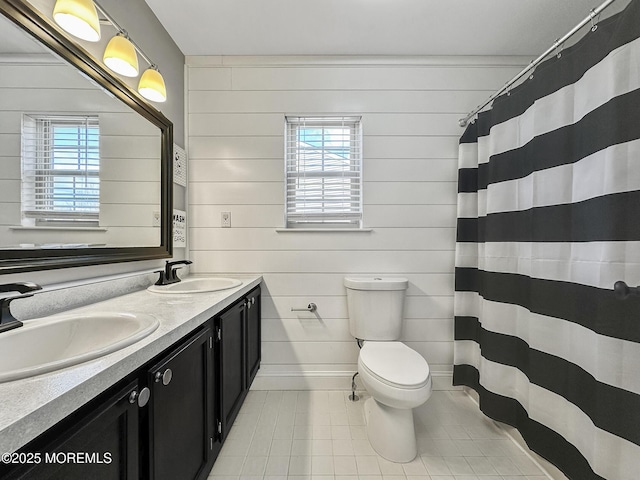 bathroom featuring vanity, curtained shower, tile patterned floors, toilet, and wood walls