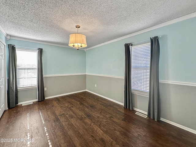 spare room featuring ornamental molding, a textured ceiling, and dark hardwood / wood-style flooring