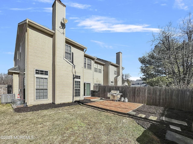 rear view of property featuring a patio area and a lawn