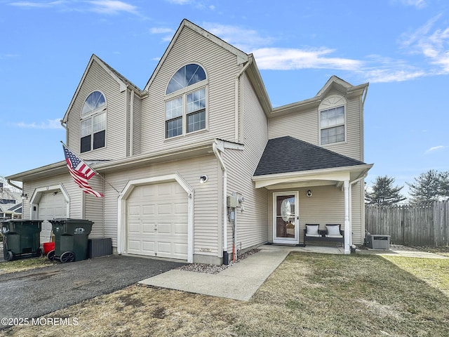 view of front property with a garage, a porch, and a front yard