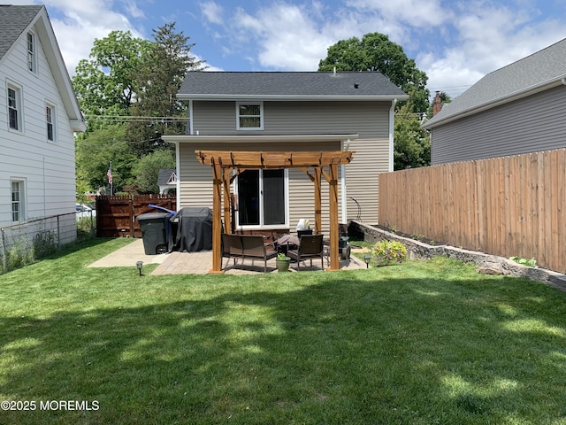 rear view of house featuring a patio area and a lawn