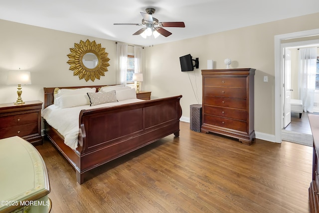 bedroom with dark hardwood / wood-style flooring and ceiling fan