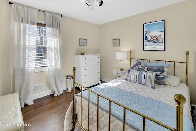 bedroom with dark wood-type flooring