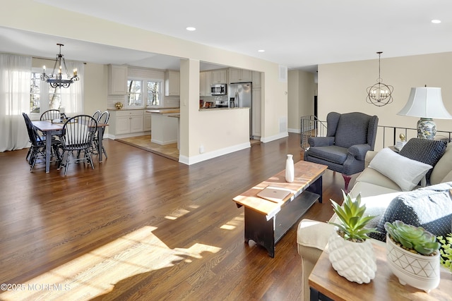 living room featuring dark hardwood / wood-style flooring and a chandelier