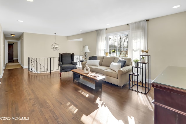 living room featuring hardwood / wood-style flooring and a chandelier