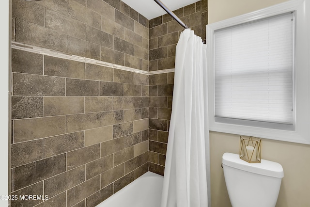 bathroom featuring toilet and shower / bath combo with shower curtain