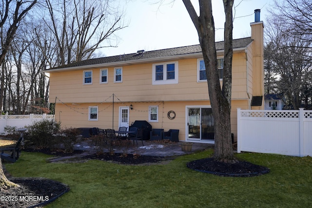 back of property featuring a patio area and a lawn