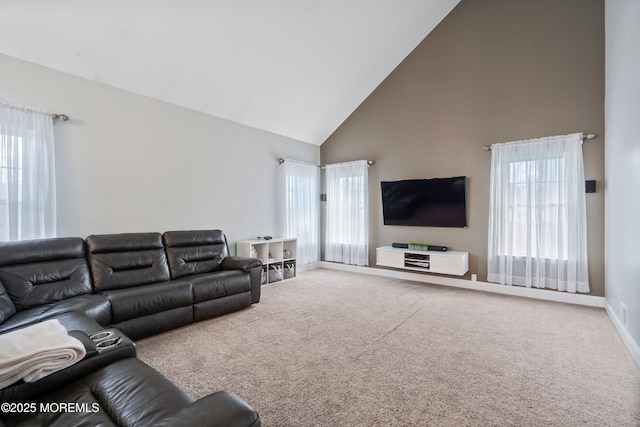 carpeted living room featuring a healthy amount of sunlight and high vaulted ceiling