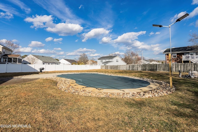 view of swimming pool with a lawn