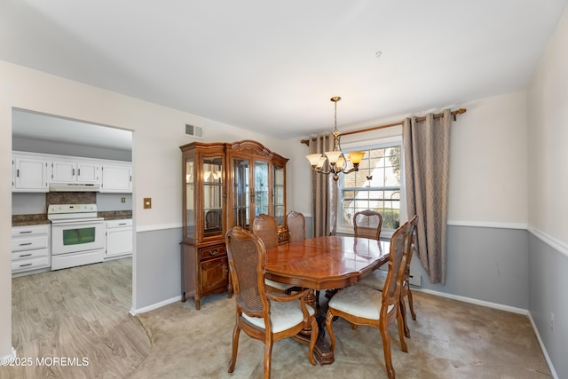 dining area featuring an inviting chandelier