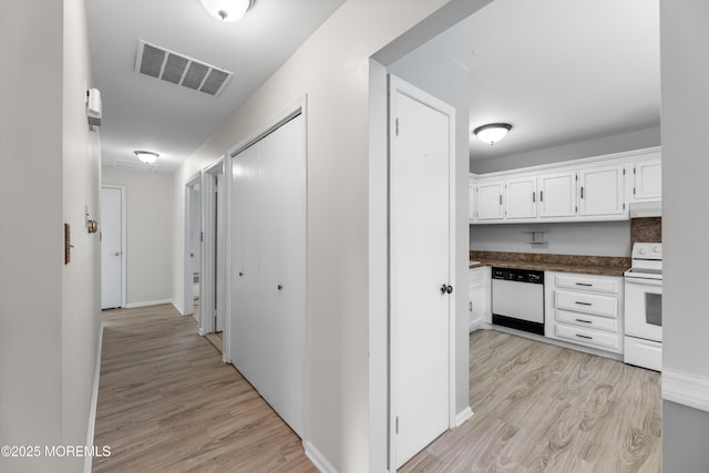 hallway with light hardwood / wood-style floors