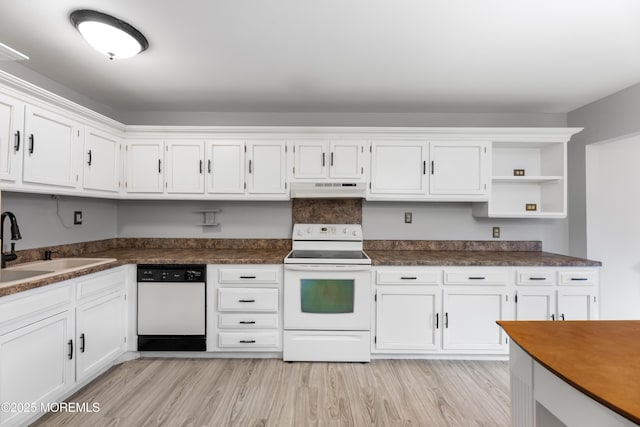 kitchen with sink, white appliances, light hardwood / wood-style flooring, and white cabinets