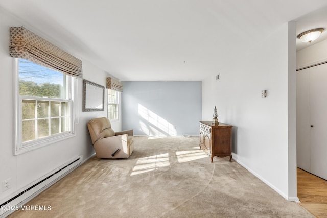 unfurnished room featuring baseboard heating and light carpet