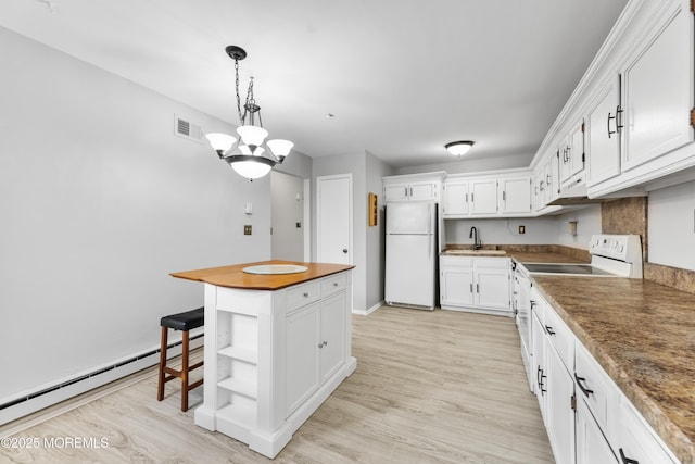 kitchen featuring sink, white appliances, a baseboard radiator, and white cabinets