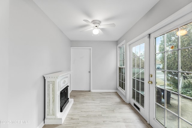 unfurnished living room featuring ceiling fan and light hardwood / wood-style floors