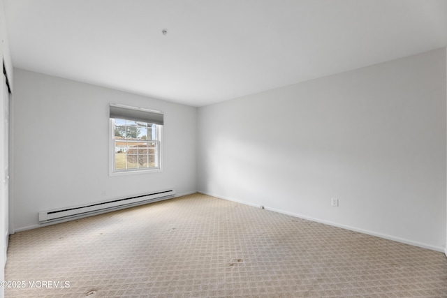 empty room with a baseboard heating unit and light colored carpet