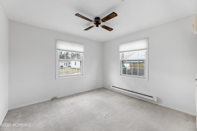 carpeted spare room with ceiling fan and baseboard heating