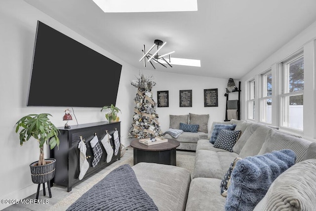 living room featuring lofted ceiling with skylight