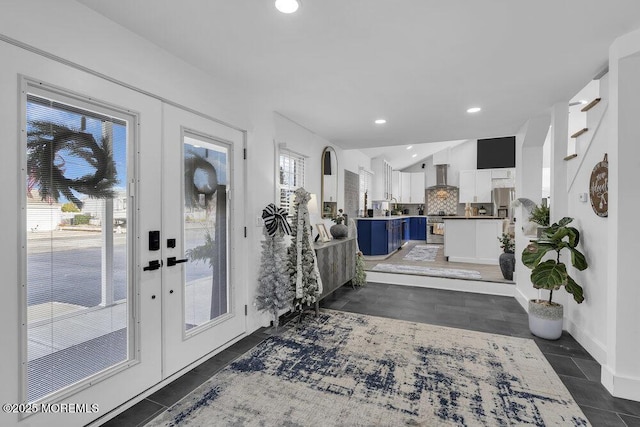 entrance foyer featuring french doors and vaulted ceiling