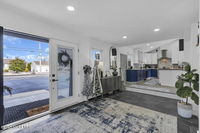 foyer featuring lofted ceiling and sink