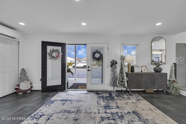 entryway featuring a wall unit AC and french doors