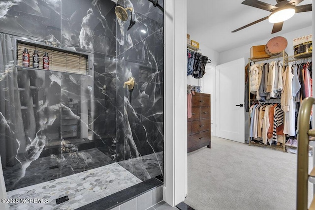 bathroom with ceiling fan and a tile shower