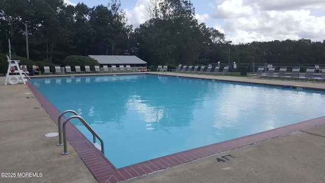 community pool featuring a patio and fence