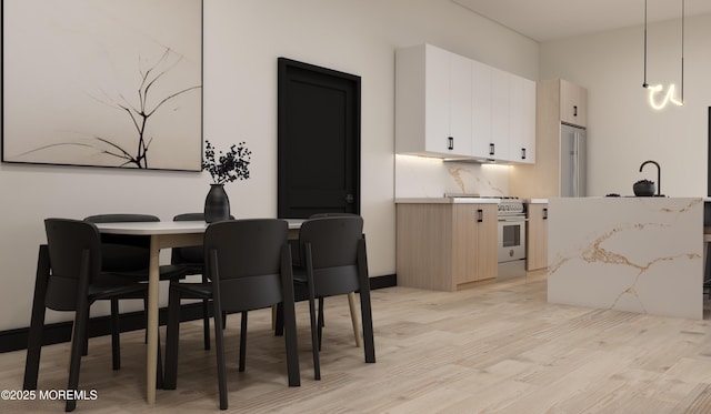 dining area featuring light wood-type flooring