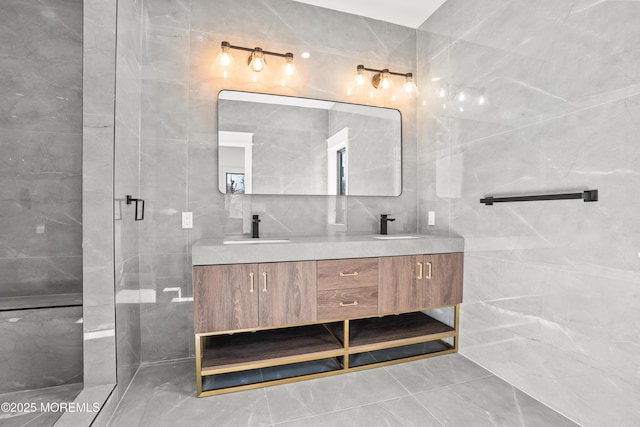 bathroom featuring tile walls, an enclosed shower, and vanity