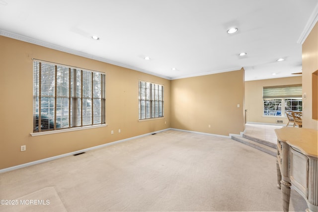 unfurnished living room featuring ornamental molding and light carpet