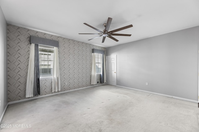 unfurnished room featuring ceiling fan, plenty of natural light, and light carpet