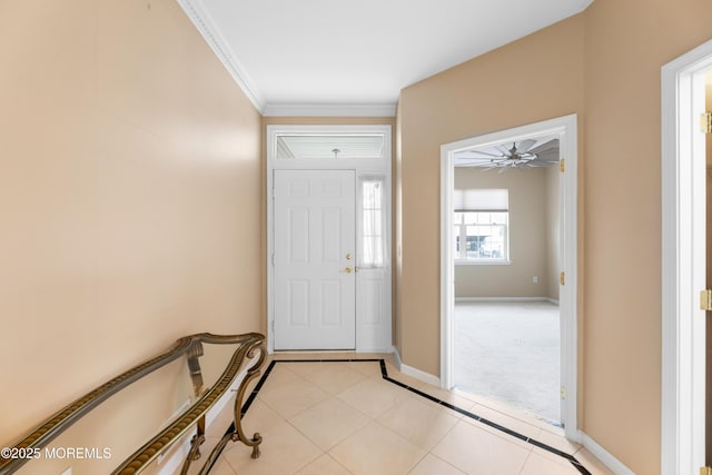 tiled entrance foyer featuring crown molding