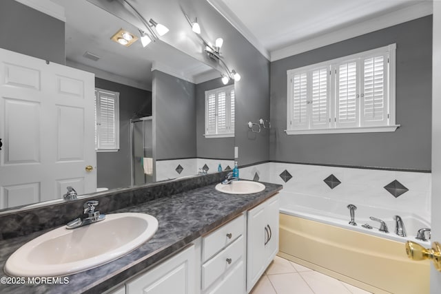 bathroom with tile patterned flooring, crown molding, shower with separate bathtub, and vanity