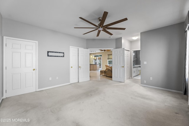 unfurnished bedroom featuring ensuite bath and light colored carpet