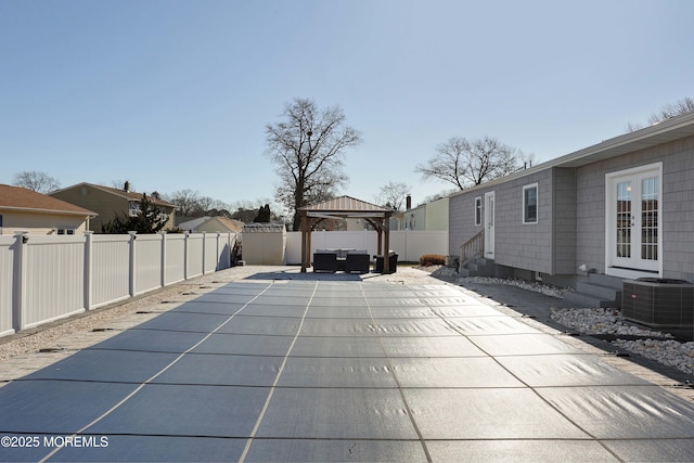 view of swimming pool with a gazebo, central AC unit, a patio, and french doors