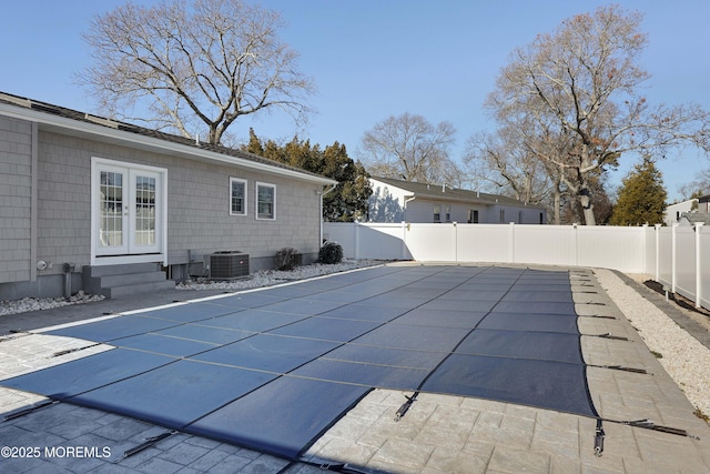 view of pool featuring a patio and central AC