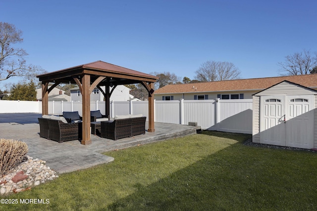 view of yard featuring a shed, an outdoor living space, a gazebo, and a patio