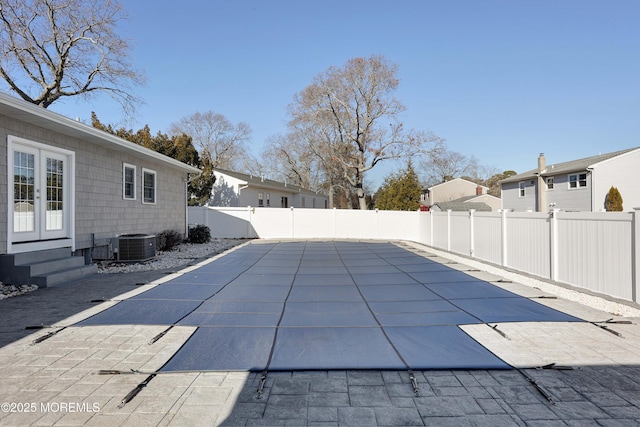 view of pool with central AC unit and a patio area