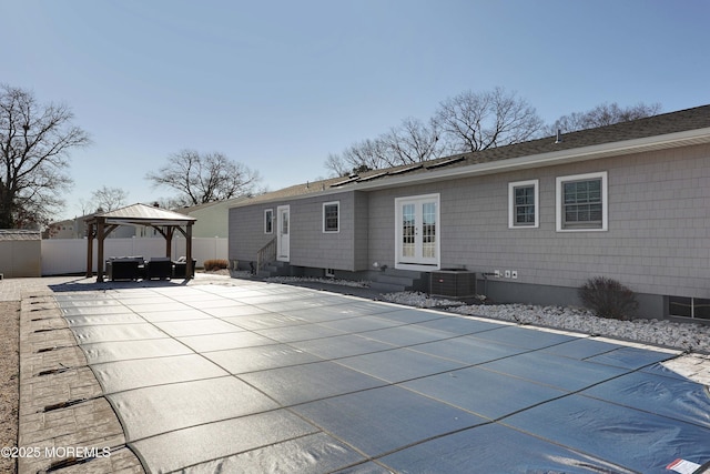 back of property featuring central AC unit, a gazebo, a patio, and french doors