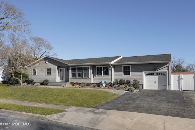 single story home featuring a garage and a front yard