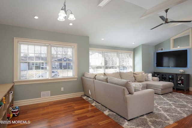 living room featuring hardwood / wood-style flooring, ceiling fan with notable chandelier, and lofted ceiling with beams