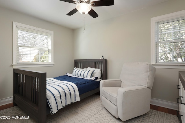 bedroom with ceiling fan and light wood-type flooring