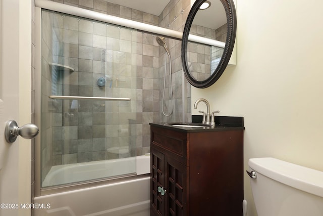 full bathroom with vanity, combined bath / shower with glass door, and toilet