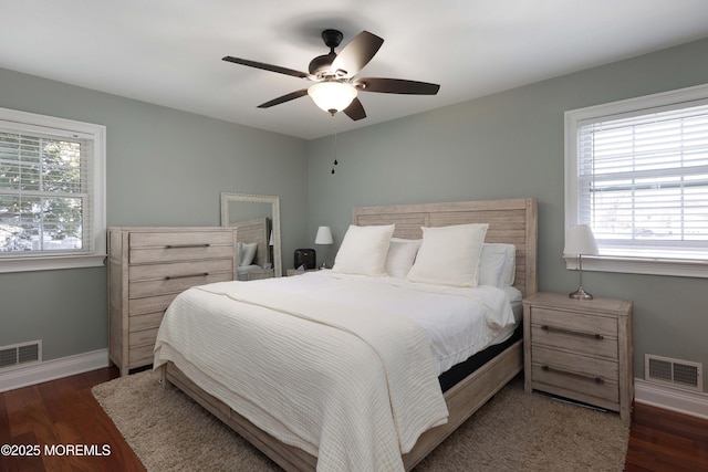 bedroom with dark hardwood / wood-style floors and ceiling fan