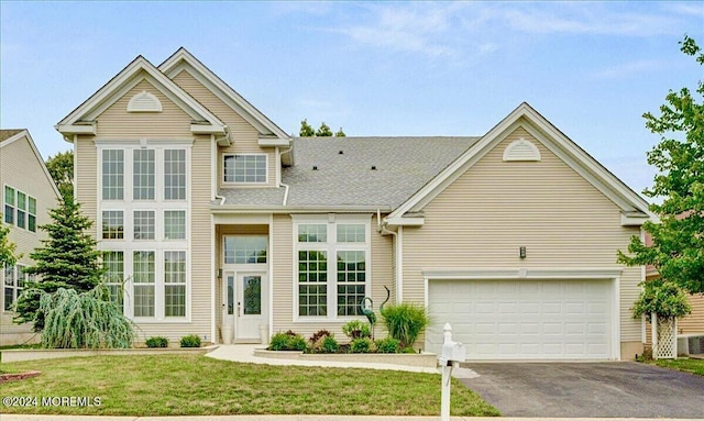 view of front facade with a garage and a front lawn