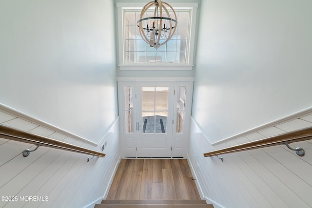 324 3rd St, Beach Haven, NJ 08008 - entrance foyer featuring a chandelier, wood finished floors, and a wainscoted wall