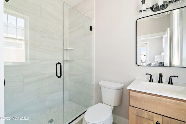 324 3rd St, Beach Haven, NJ 08008 - bathroom with toilet, a stall shower, vanity, baseboards, and healthy amount of natural light