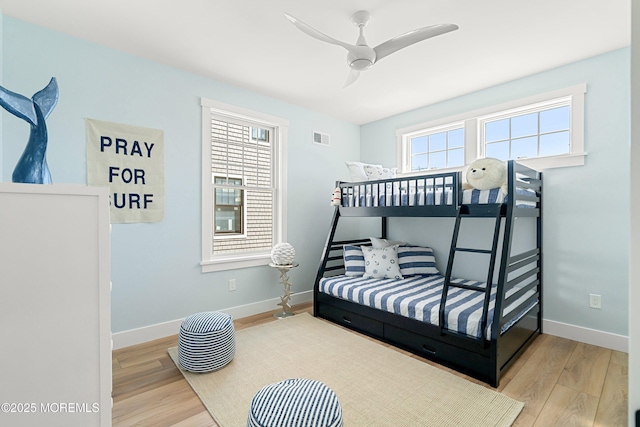 324 3rd St, Beach Haven, NJ 08008 - bedroom with wood finished floors, multiple windows, baseboards, and ceiling fan